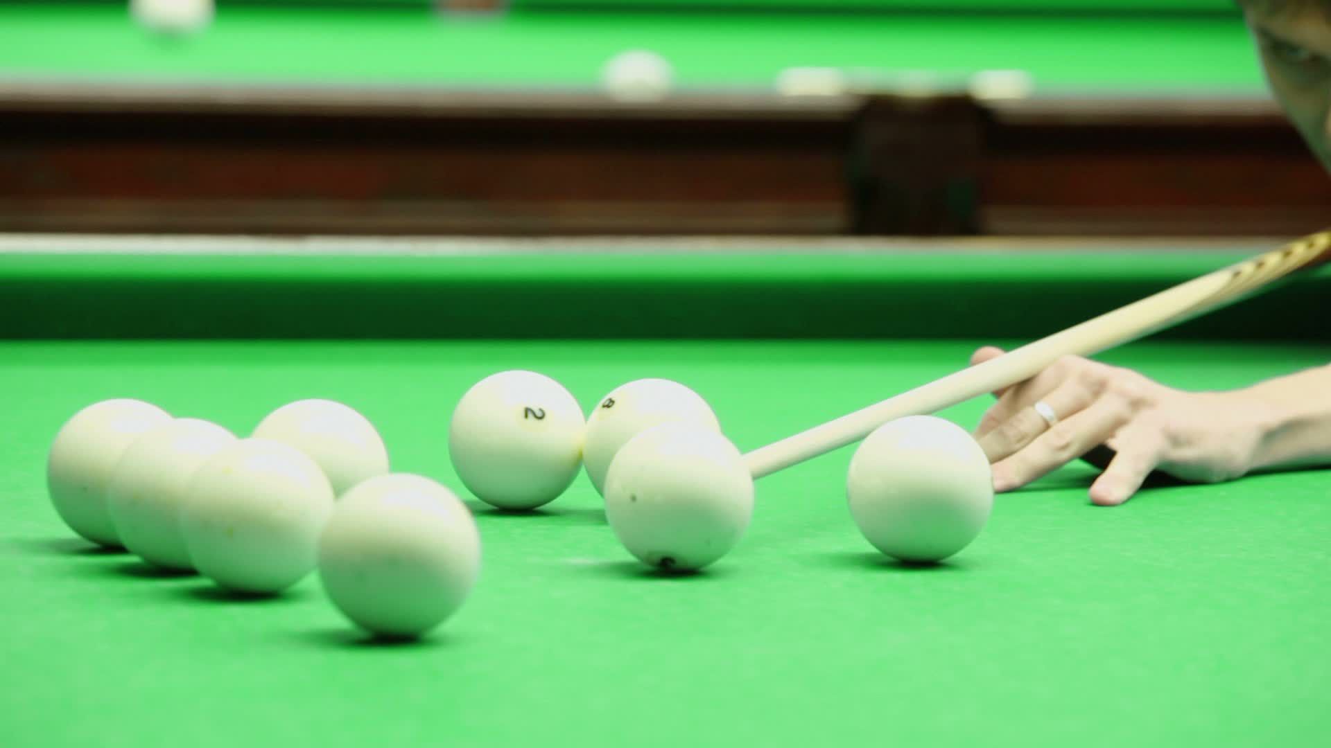 АЛИВАН часы бельярд. A close-up of a Billiard Ball in Mid-Air, about to be Hit by a cue..